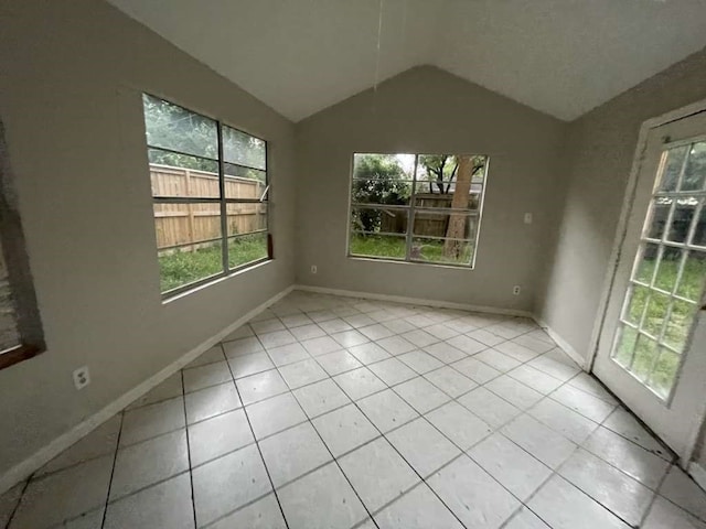 interior space featuring lofted ceiling and light tile patterned flooring