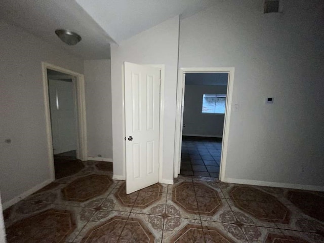 interior space with lofted ceiling and tile patterned flooring