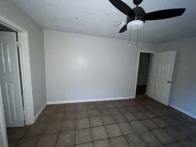 tiled empty room with ceiling fan