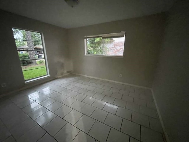 tiled spare room with plenty of natural light