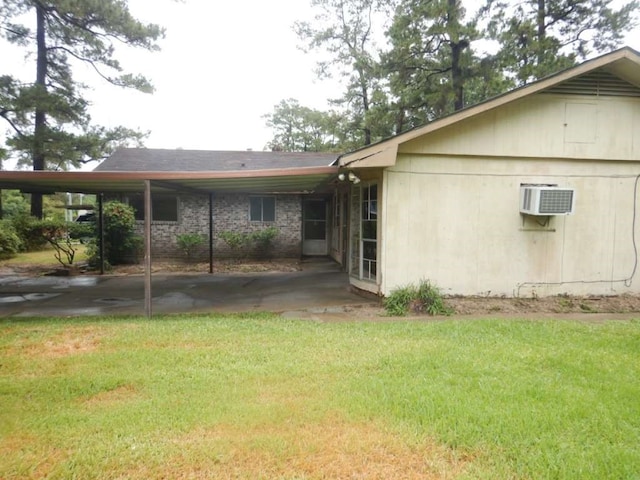 rear view of house featuring a wall mounted AC and a lawn