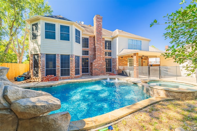 view of pool featuring an in ground hot tub