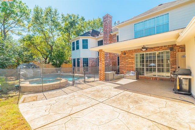 exterior space featuring a patio, an in ground hot tub, and ceiling fan