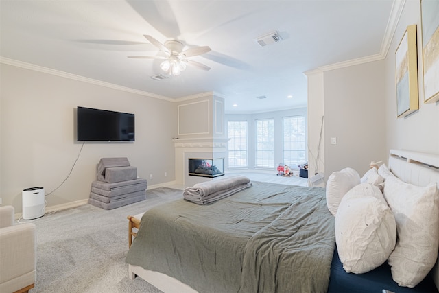 carpeted bedroom with ceiling fan and crown molding