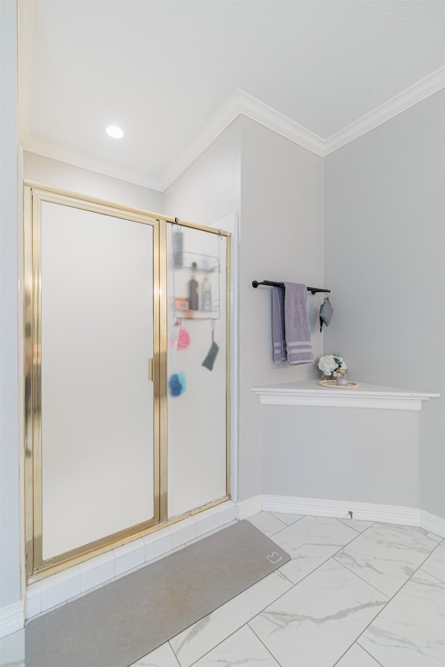 bathroom with a shower with door and crown molding