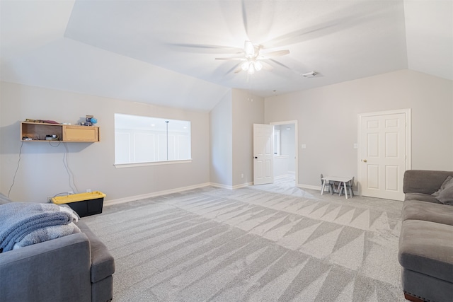 living room with ceiling fan, light carpet, and vaulted ceiling