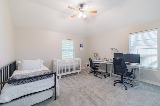 bedroom featuring light colored carpet, vaulted ceiling, and ceiling fan