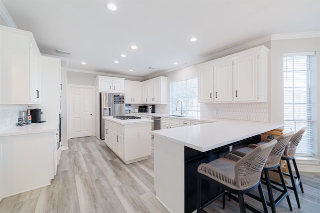 kitchen featuring a kitchen breakfast bar, decorative backsplash, a center island, and a wealth of natural light