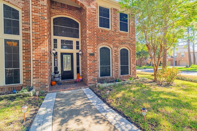 doorway to property featuring a lawn