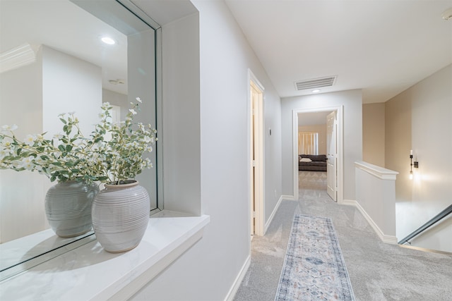 hallway with light colored carpet