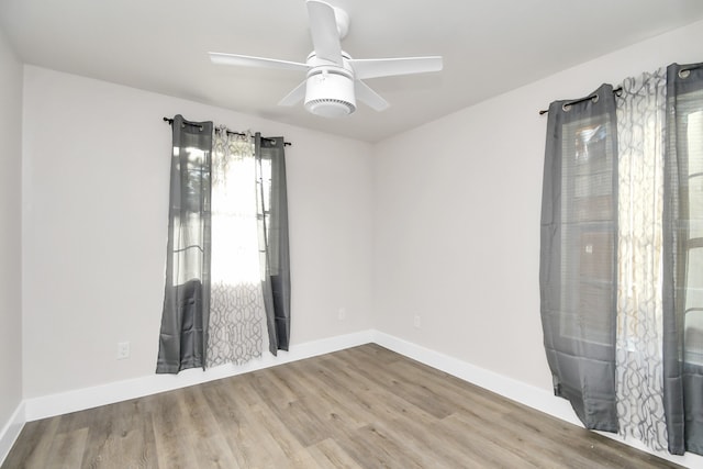 unfurnished room featuring ceiling fan and wood-type flooring