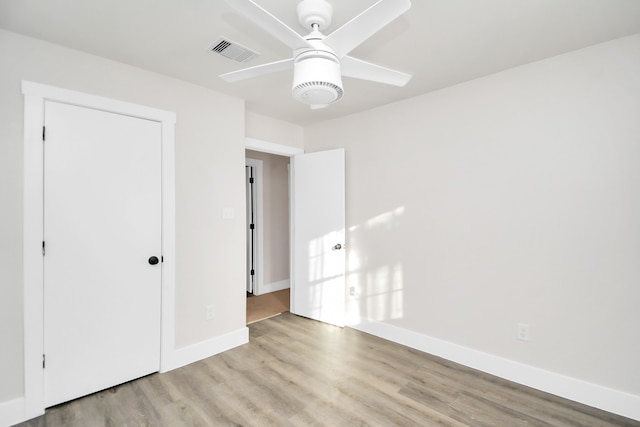 unfurnished bedroom featuring light hardwood / wood-style flooring, a closet, and ceiling fan