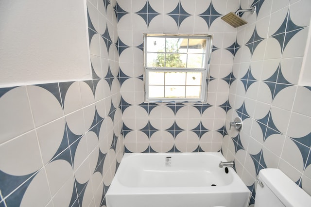 bathroom featuring toilet, tile walls, and shower / bathtub combination