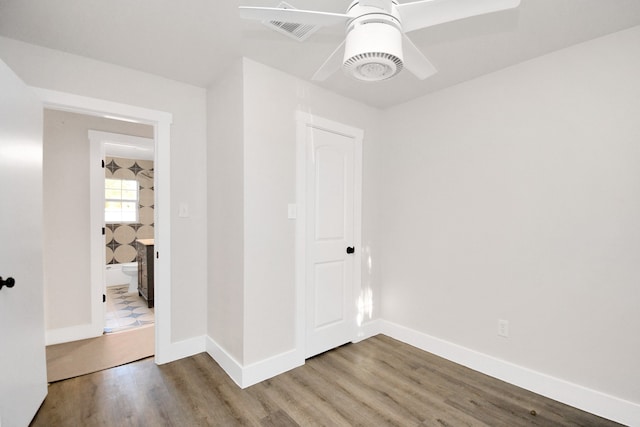 empty room with hardwood / wood-style floors and ceiling fan