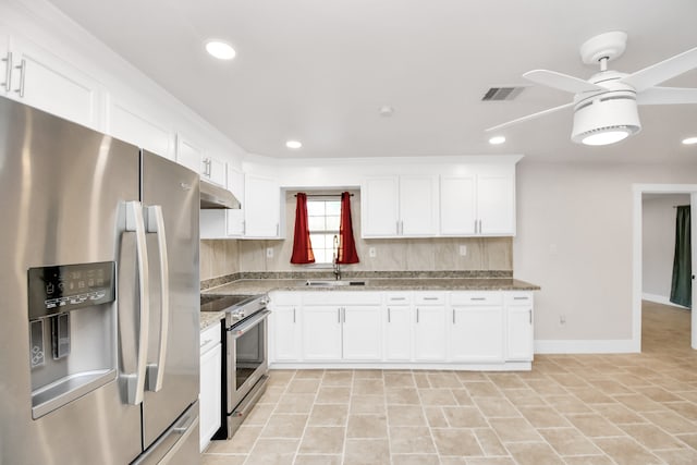 kitchen featuring ceiling fan, appliances with stainless steel finishes, white cabinetry, stone countertops, and sink