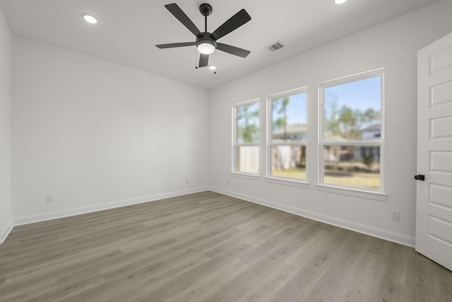 spare room featuring light hardwood / wood-style floors and ceiling fan