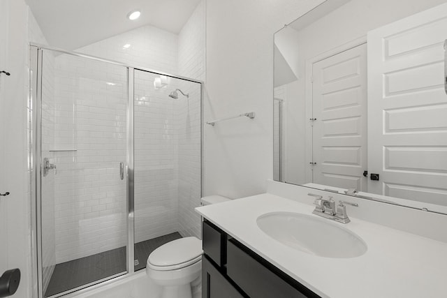 bathroom with walk in shower, lofted ceiling, toilet, and vanity