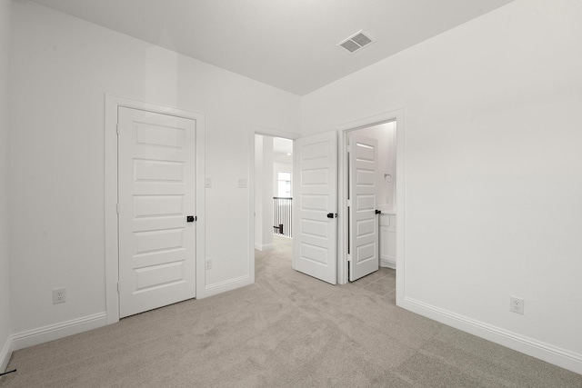 unfurnished bedroom with light carpet