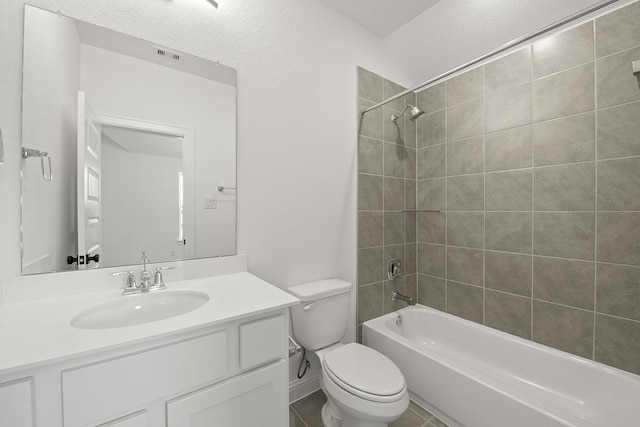 full bathroom with vanity, toilet, and tiled shower / bath