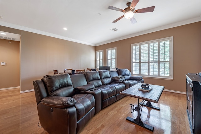 living room featuring ornamental molding, light hardwood / wood-style flooring, and ceiling fan