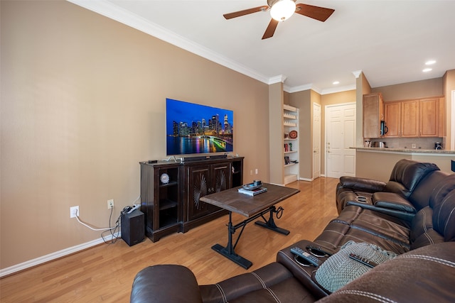 living room featuring crown molding, built in shelves, light wood-type flooring, and ceiling fan