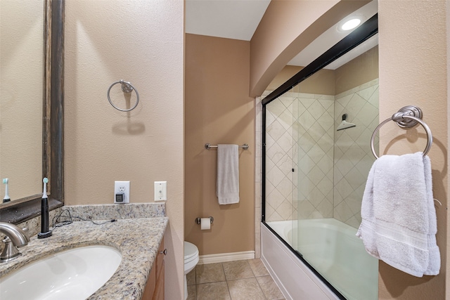 full bathroom with toilet, combined bath / shower with glass door, vanity, and tile patterned floors