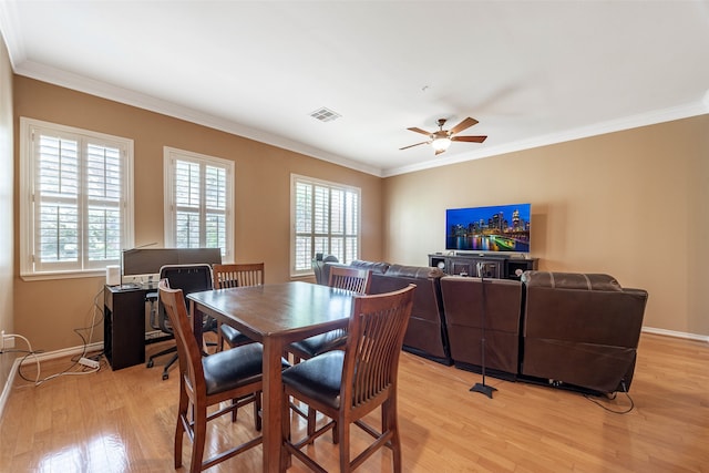 dining room with light hardwood / wood-style flooring, ceiling fan, and crown molding