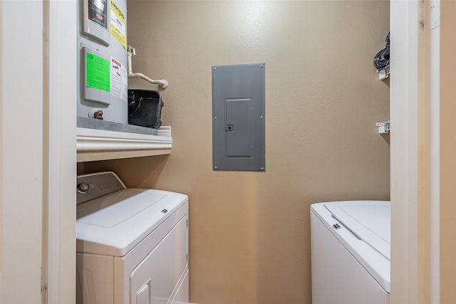 clothes washing area featuring electric panel and separate washer and dryer