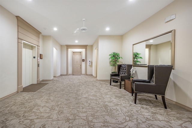 sitting room with elevator and ceiling fan