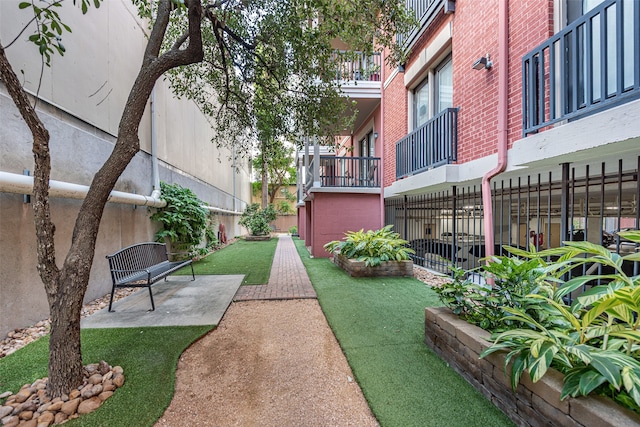 view of property's community with a yard and a patio