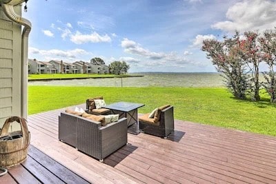 wooden terrace featuring a yard and a water view