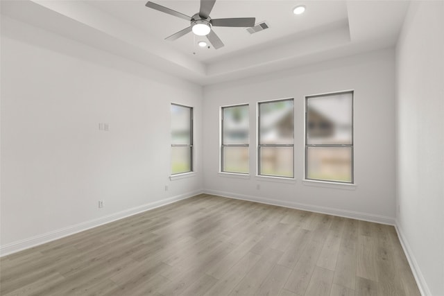 22067 Breakwater Ln, Porter, TX 77365 - empty room featuring a raised ceiling, light wood-style floors, ceiling fan, baseboards, and recessed lighting