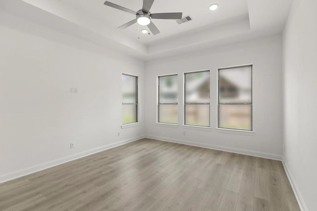 22067 Breakwater Ln, Porter, TX 77365 - empty room featuring a tray ceiling, light wood-style flooring, baseboards, a ceiling fan, and recessed lighting