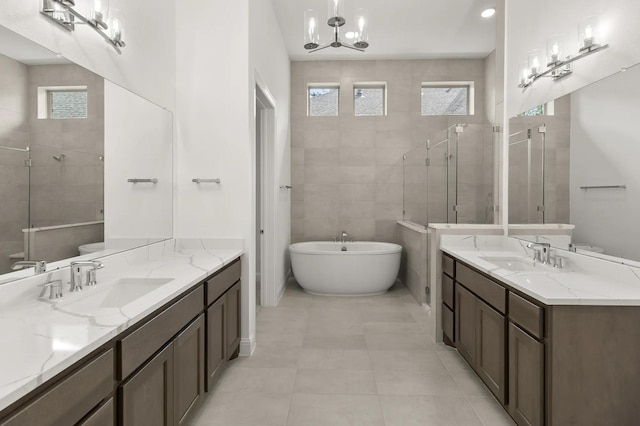22067 Breakwater Ln, Porter, TX 77365 - full bath featuring two vanities, a shower stall, a freestanding tub, toilet, and a chandelier
