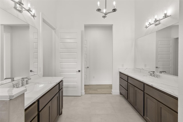22067 Breakwater Ln, Porter, TX 77365 - full bath featuring two vanities, baseboards, and a chandelier