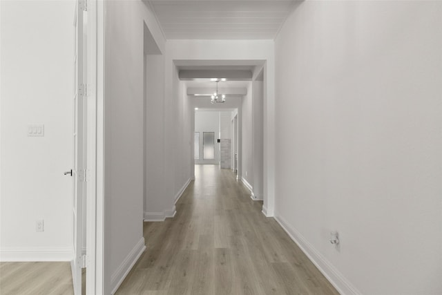 22067 Breakwater Ln, Porter, TX 77365 - hallway with light wood-style flooring, baseboards, and a chandelier