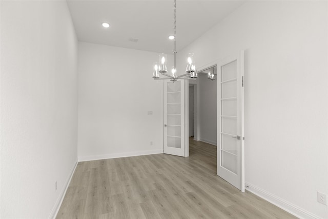22067 Breakwater Ln, Porter, TX 77365 - spare room with a chandelier, light wood-style flooring, recessed lighting, baseboards, and french doors