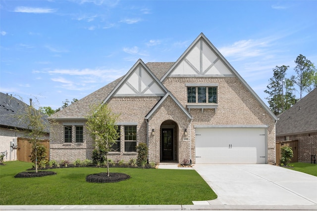 22067 Breakwater Ln, Porter, TX 77365 - tudor home featuring brick siding, driveway, stucco siding, and roof with shingles