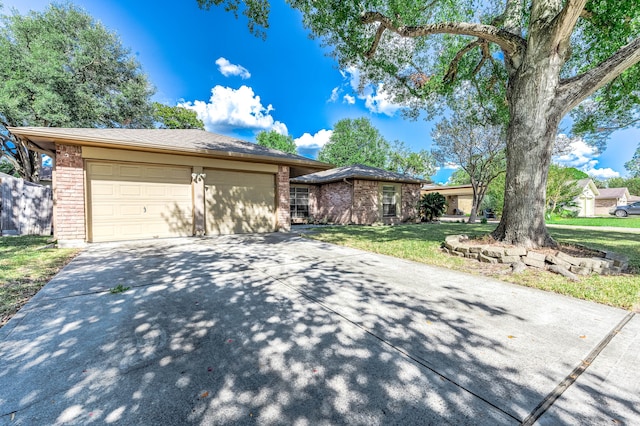 view of front of house with a front yard and a garage