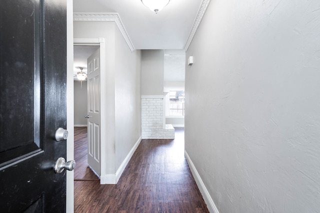 corridor with ornamental molding and dark hardwood / wood-style floors