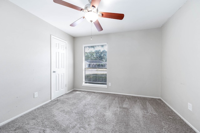 carpeted spare room with ceiling fan