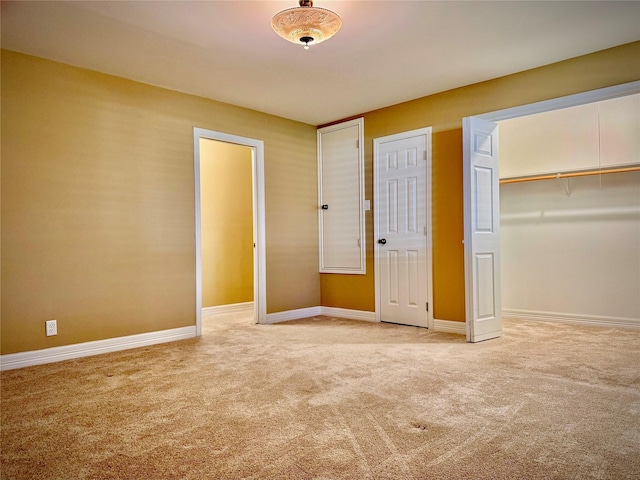 unfurnished bedroom featuring carpet floors, baseboards, and a closet