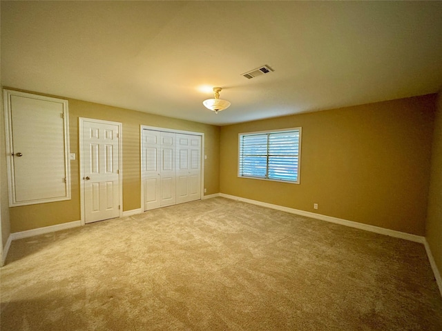 unfurnished bedroom with visible vents, baseboards, and carpet floors