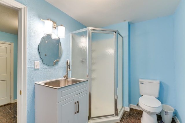 bathroom with vanity, toilet, a shower with shower door, and tile patterned flooring