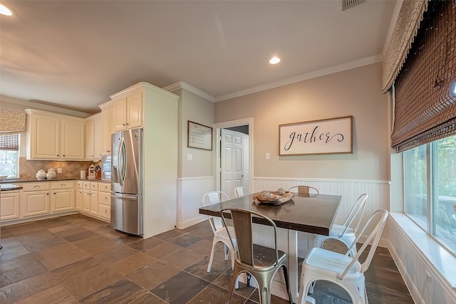 kitchen with decorative backsplash, stainless steel fridge with ice dispenser, a healthy amount of sunlight, and ornamental molding