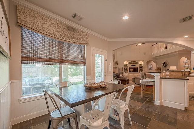 dining room featuring sink and crown molding