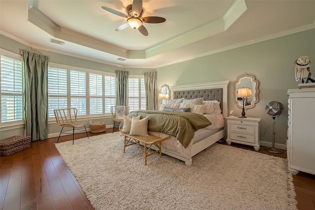 bedroom with dark hardwood / wood-style floors, multiple windows, crown molding, and ceiling fan