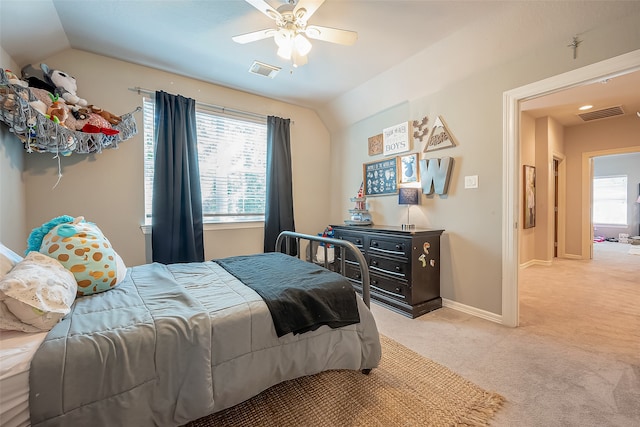 carpeted bedroom featuring ceiling fan, lofted ceiling, and multiple windows