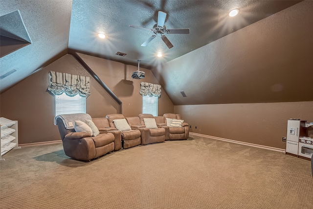 carpeted cinema room featuring a textured ceiling, ceiling fan, and lofted ceiling