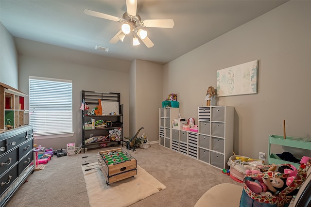 playroom with carpet and ceiling fan